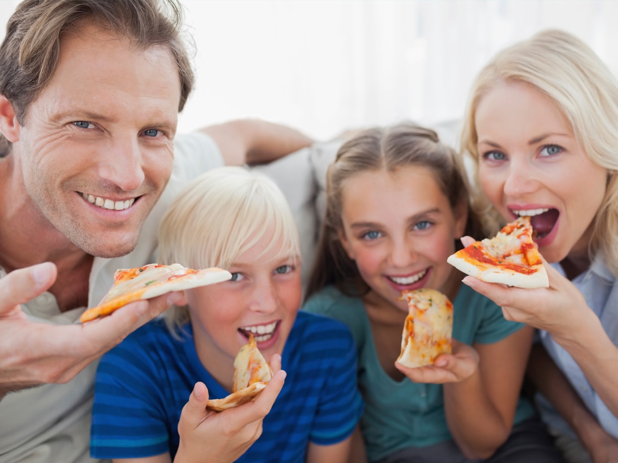 Family saving money and having pizza.